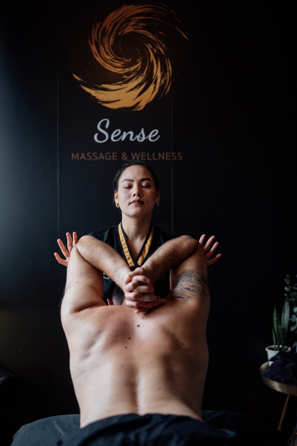 Therapist combining deep tissue pressure with guided Thai-style stretching