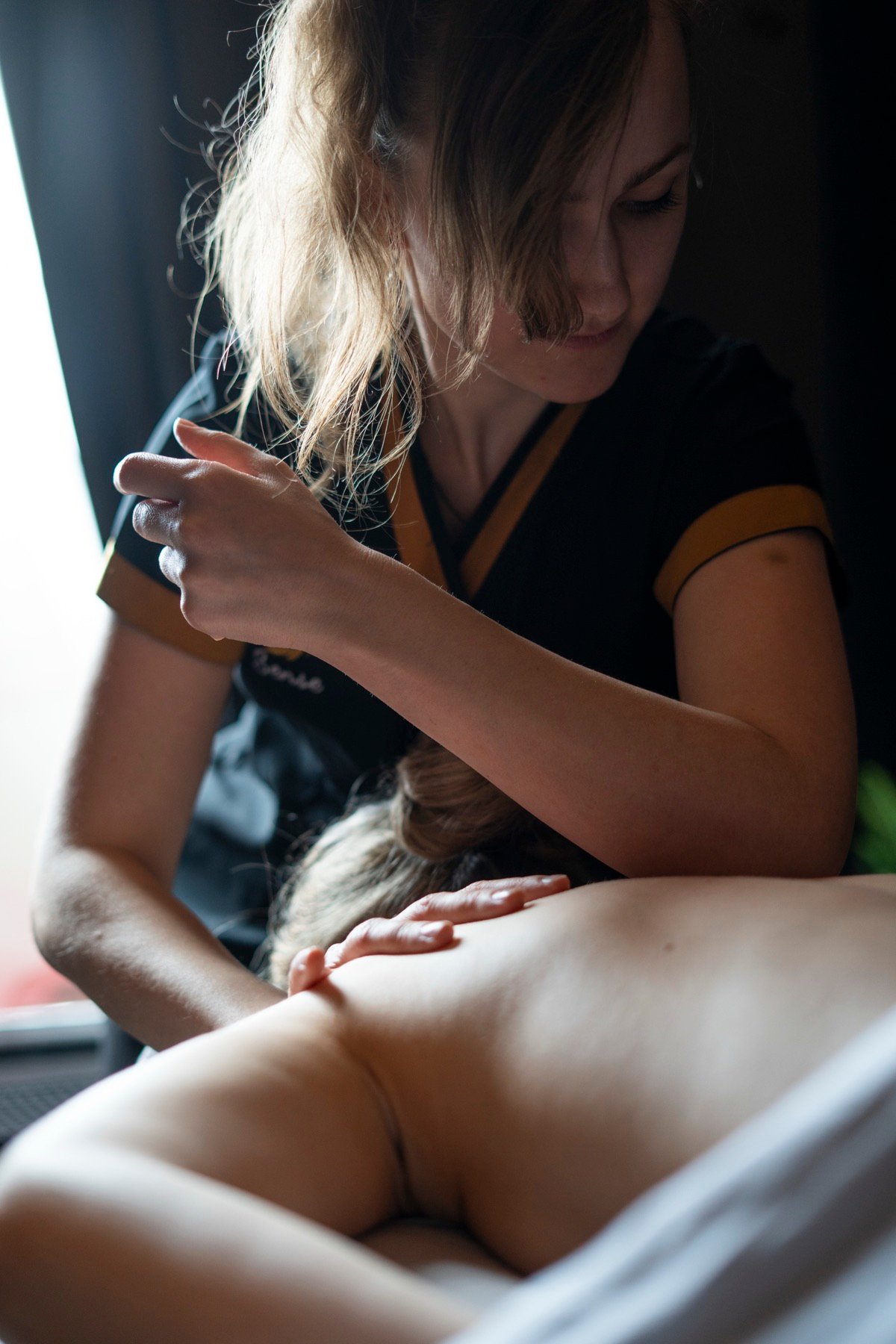 Therapist applying firm pressure into shoulder tension